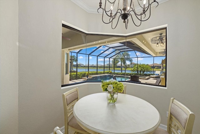 dining area featuring a water view, crown molding, and plenty of natural light