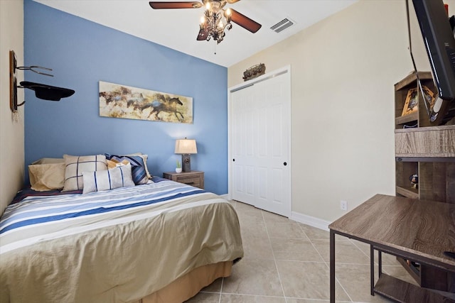 bedroom featuring a closet, light tile patterned flooring, and ceiling fan