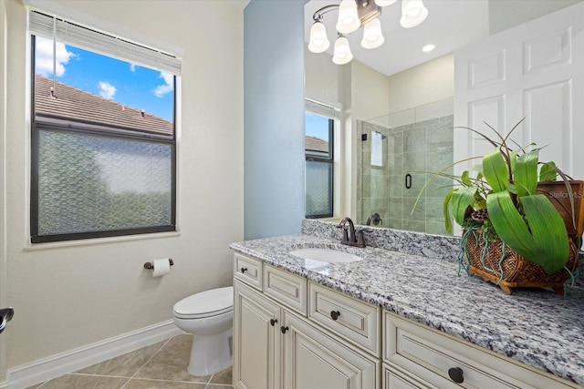 bathroom featuring vanity, tile patterned flooring, toilet, and an enclosed shower