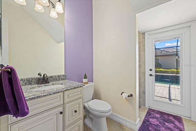 bathroom with vanity, toilet, and tile patterned flooring