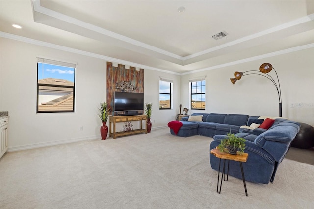 carpeted living room with crown molding and a tray ceiling