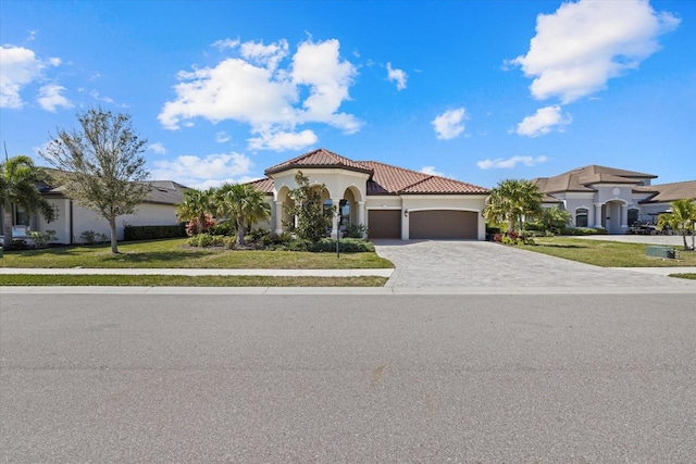 mediterranean / spanish home with a front yard and a garage