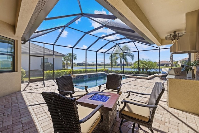 view of patio with a water view and glass enclosure