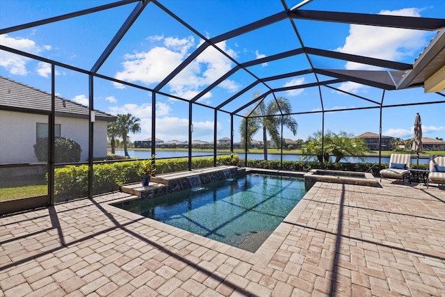 view of pool featuring a patio, an in ground hot tub, a water view, and glass enclosure