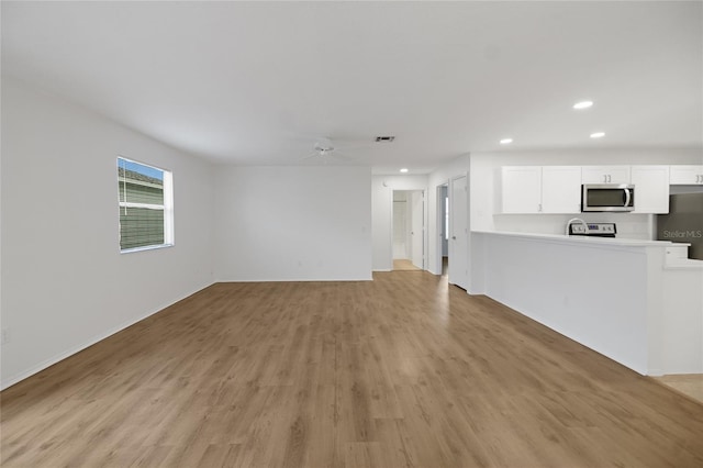 unfurnished living room with ceiling fan and light wood-type flooring