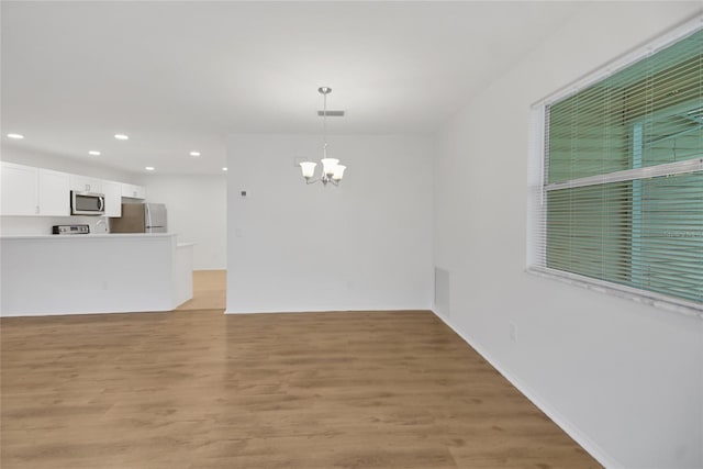 interior space with an inviting chandelier and light wood-type flooring