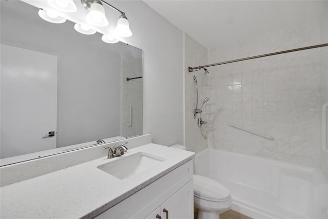 full bathroom featuring vanity, tiled shower / bath combo, and toilet