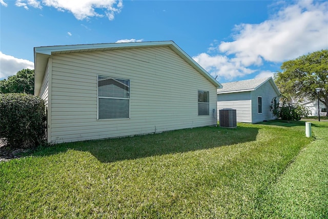 back of property with cooling unit and a lawn