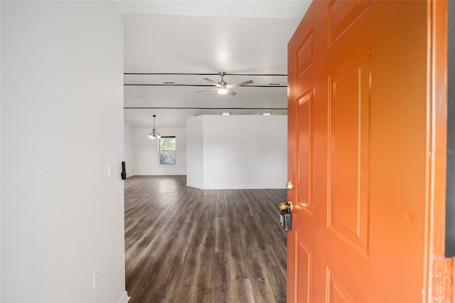 interior space with ceiling fan and dark hardwood / wood-style flooring