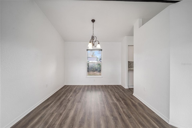 unfurnished dining area featuring dark wood-type flooring and a chandelier