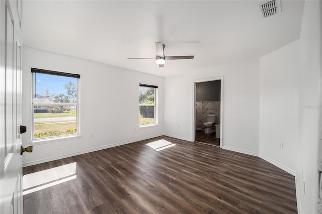 empty room featuring ceiling fan and dark hardwood / wood-style flooring