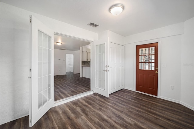 entryway with french doors and dark hardwood / wood-style flooring