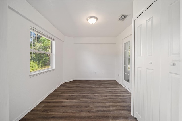 spare room featuring dark hardwood / wood-style floors