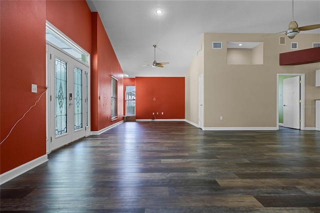 foyer with high vaulted ceiling, dark hardwood / wood-style flooring, and french doors