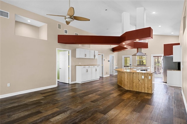 kitchen featuring an island with sink, dark hardwood / wood-style floors, white cabinetry, and high vaulted ceiling