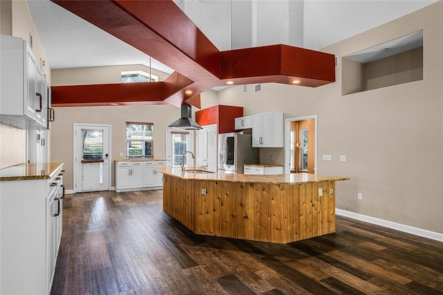 kitchen featuring white cabinetry, dark wood-type flooring, sink, and stainless steel fridge with ice dispenser