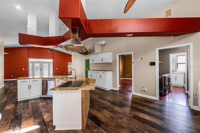 kitchen with a wealth of natural light, white cabinetry, kitchen peninsula, and appliances with stainless steel finishes