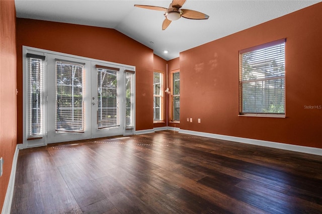 spare room featuring french doors, dark wood-type flooring, ceiling fan, and vaulted ceiling