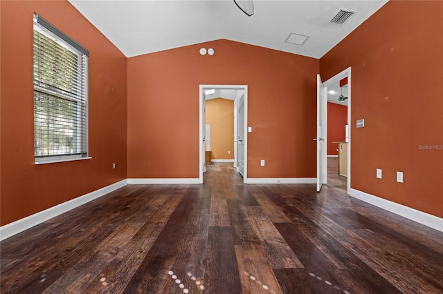 empty room featuring dark hardwood / wood-style flooring and lofted ceiling