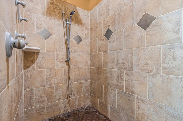 bathroom with tiled shower