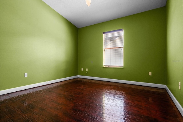 spare room featuring hardwood / wood-style flooring, ceiling fan, and lofted ceiling