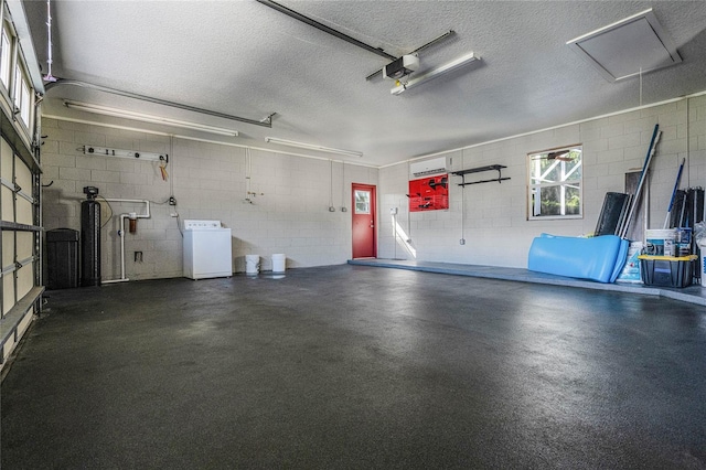 garage with washer / clothes dryer and a garage door opener