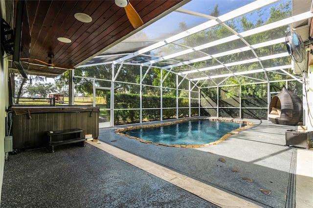 view of pool with a lanai, a hot tub, and a patio area