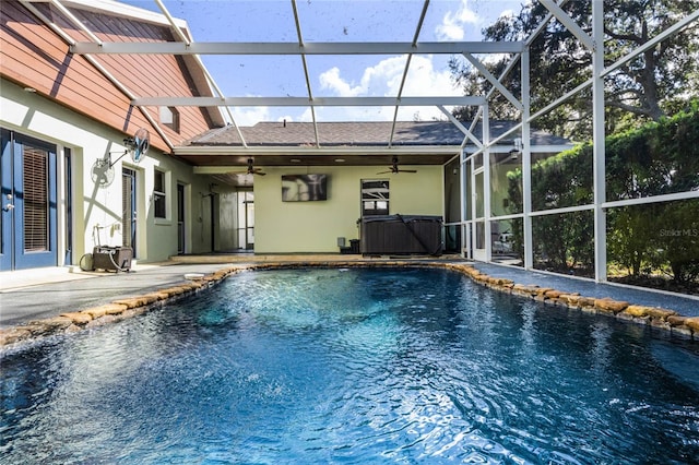 view of pool with a lanai, ceiling fan, and a patio