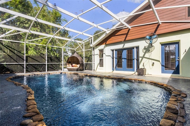 view of swimming pool with a lanai, french doors, and a patio