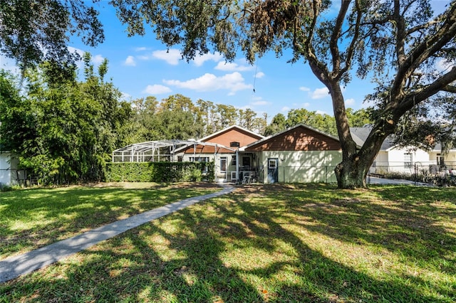 ranch-style home featuring a front yard and a lanai