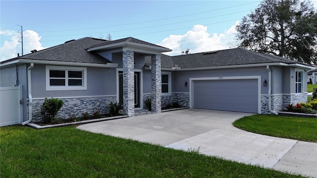 prairie-style house featuring a garage, stone siding, concrete driveway, and stucco siding