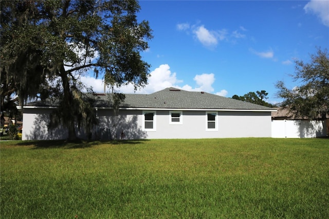 back of property featuring a lawn