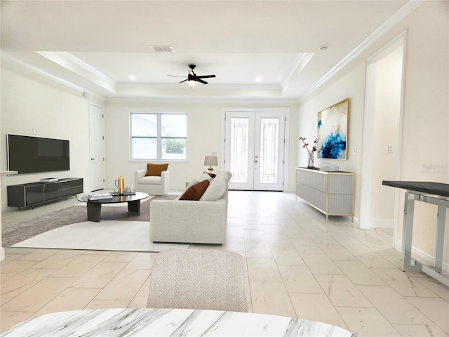 living room with marble finish floor, visible vents, a raised ceiling, and french doors