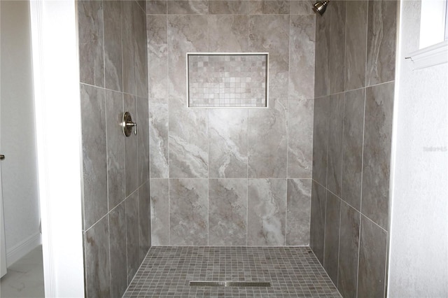 full bath with tiled shower