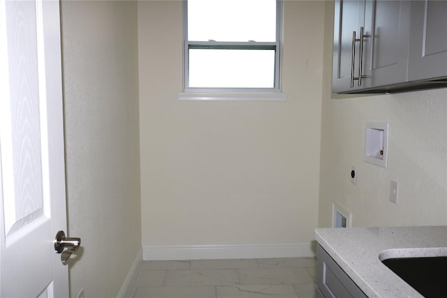 laundry area with washer hookup, marble finish floor, cabinet space, electric dryer hookup, and baseboards