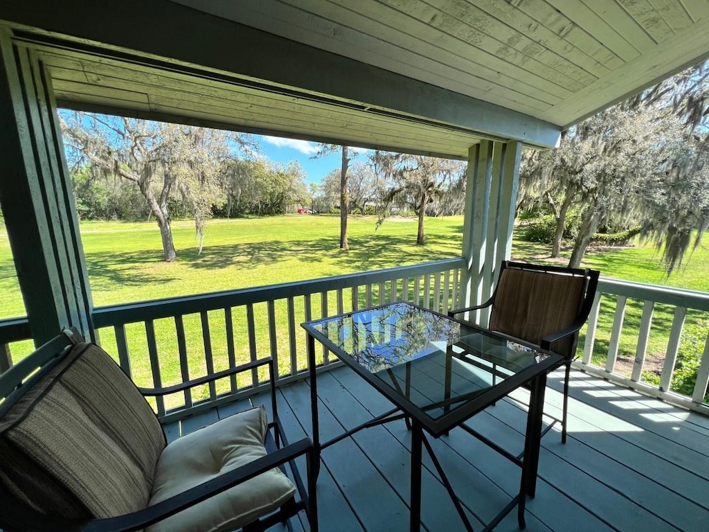 wooden deck with a lawn