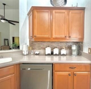 kitchen featuring dishwasher, backsplash, ceiling fan, and sink