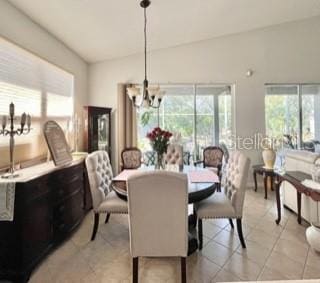 dining room featuring light tile patterned floors and an inviting chandelier