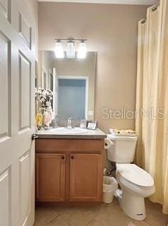 119 Crescent Moon Dr, Groveland, FL 34736 - bathroom featuring vanity, tile patterned flooring, toilet, and a shower with curtain