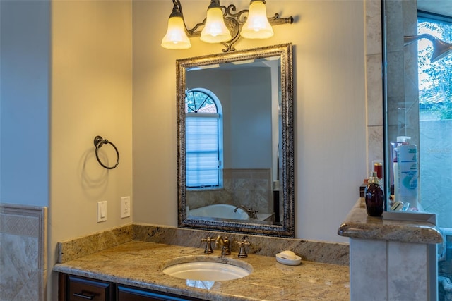 bathroom with a bathing tub, vanity, a healthy amount of sunlight, and an inviting chandelier