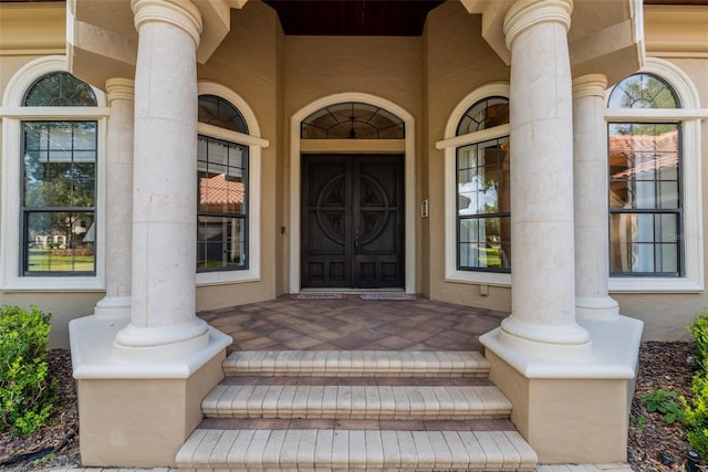 view of exterior entry with covered porch