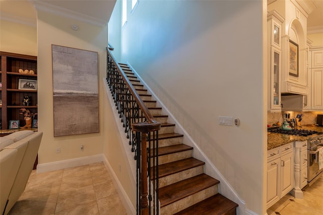 stairs featuring tile patterned flooring and ornamental molding