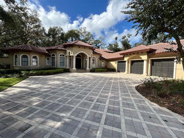 mediterranean / spanish-style house with a garage