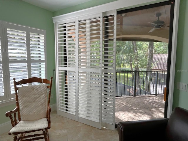 interior space with ceiling fan and light tile patterned floors