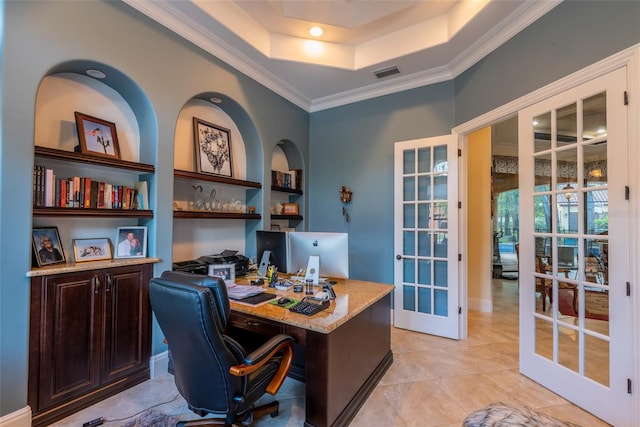 tiled home office with built in shelves, a raised ceiling, crown molding, and french doors