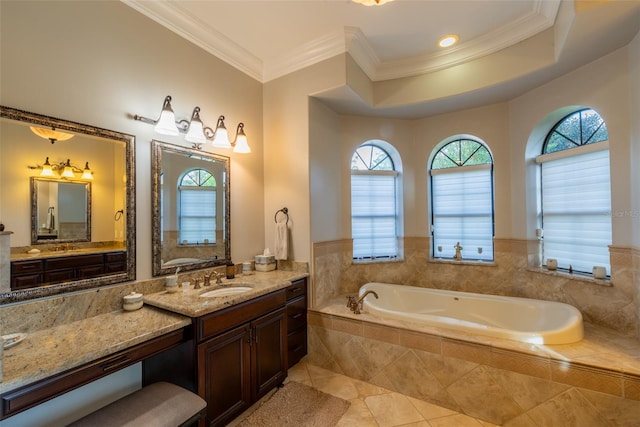 bathroom featuring tiled tub, crown molding, tile patterned flooring, and vanity