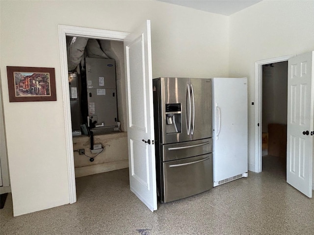 kitchen featuring heating unit and stainless steel fridge