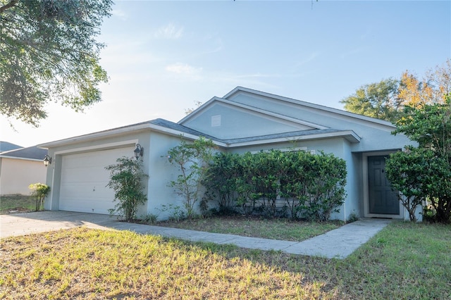 ranch-style home with a front lawn and a garage