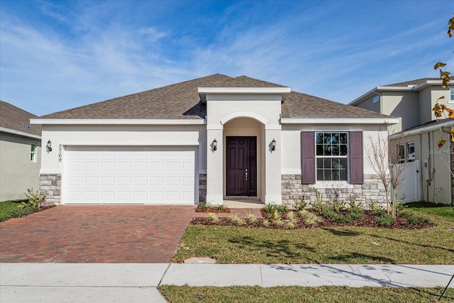 view of front of home with a front yard and a garage