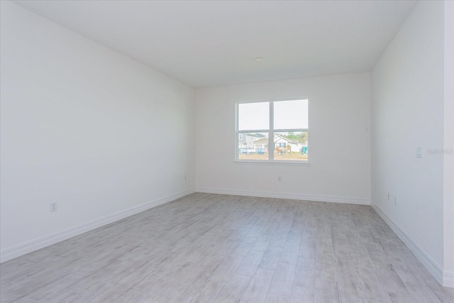 unfurnished room with light wood-type flooring